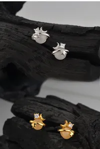 Detail of S925 silver star and moon planet stud earrings with white agate inlay