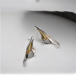Detail of S925 silver flower stud earrings with two-tone petal design and modern texture