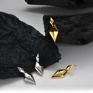 Macro detail of geometric rhombus earrings in S925 sterling silver with mirror finish