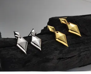 Macro detail of geometric S925 sterling silver diamond-shaped earrings with polished finish
