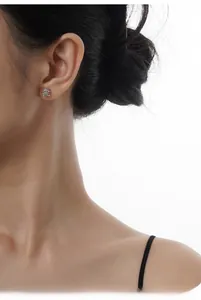 Close-up of S925 silver star moon stud earring with white agate on female model