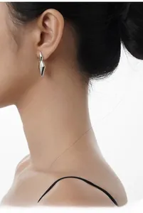 Close-up of polished S925 sterling silver geometric diamond drop earrings on a model