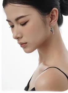 Detail of elegant S925 sterling silver long flower earrings worn by a model