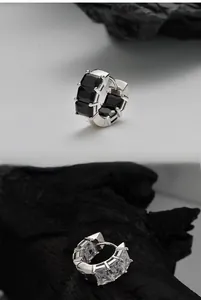 Close-up of geometric S925 silver hoop earrings with rectangular step-cut zircon stones