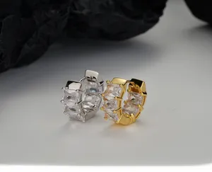 Macro view of wide silver hoop earrings with emerald-cut cubic zirconia inlays