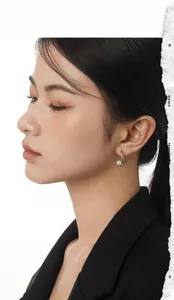 Detail of S925 silver hoop earring with white pearl on model's ear for elegant look