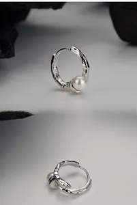 Close-up of S925 sterling silver hoop earrings with white pearl and micro-pave crystals