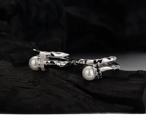 Detailed view of silver branch texture ring with large white pearl and pave set crystals