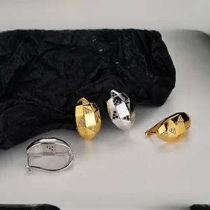 Dettaglio di orecchini geometrici in argento con pavé di zirconi cubici scintillanti
