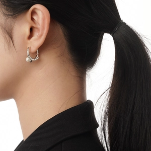 S925 Sterling silver hoop earring with pearl and black star charm worn by model