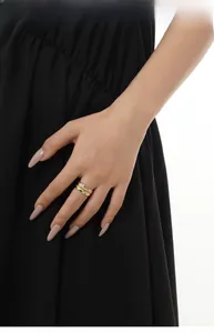 Detail of two-tone S925 sterling silver ring with irregular hammered texture on model's finger