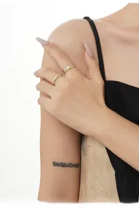 Detail of two-tone S925 silver rings with unique irregular texture on model's hand