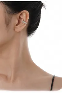 Macro detail of S925 sterling silver ear cuff with shimmering opal and micro-set cubic zirconia