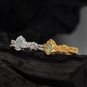 S925 silver irregular lava texture ring with pear shaped opal on dark wood base