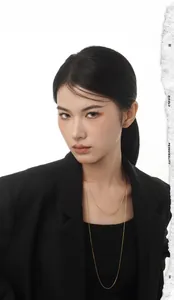 Close-up of layered gold snake bone necklaces on a model with minimalist chic style