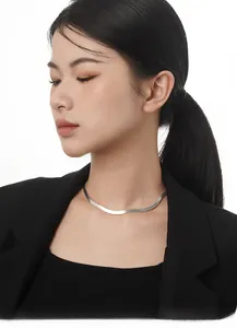Minimalist S925 sterling silver flat snake bone necklace worn on a black suit blazer