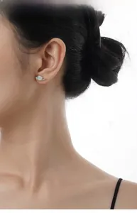 Detail of S925 sterling silver moon earring with colorful opal and sparkling diamonds