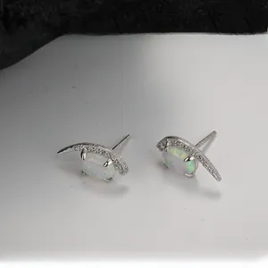 Detail view of S925 silver crescent moon stud earrings with oval opal stone and small diamonds