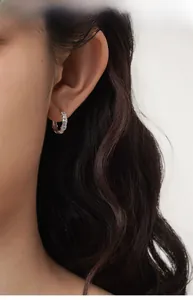 Close-up of S925 sterling silver bamboo hoop earrings with shiny zircon stones