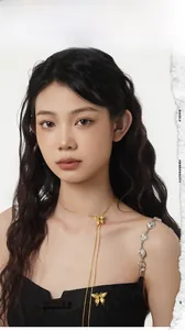 Detailed view of elegant gold butterfly necklace worn by a model with long chain design