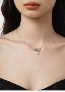 Detail of silver S925 butterfly necklace with sparkling teardrop zircon on neck