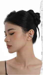 Close-up of irregular liquid silver ear cuff worn by model on ear cartilage detail