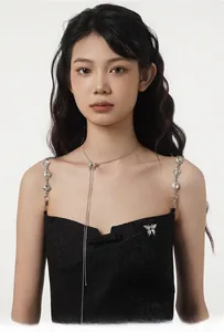 Detail of S925 silver butterfly necklace on model with elegant jacquard camisole