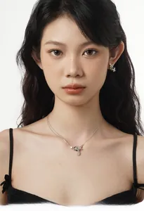 Silver S925 butterfly necklace and earrings set with crystals shown on a female model