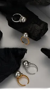 Detail of s925 silver open rings with dark grey pearls and twisted pave zircon settings