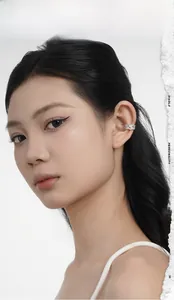 Close-up of geometric S925 sterling silver ear cuff with sparkling pavé cubic zirconia