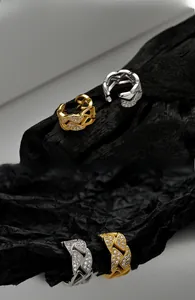 Macro detail of hollow geometric ear cuffs with pave zircons in gold and silver finish
