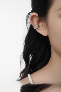 Detail of silver S925 sterling silver ear cuff with anchor chain design and micro zircons