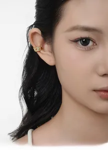 Close-up of gold double-chain ear cuff with micro-pave diamonds on model's ear