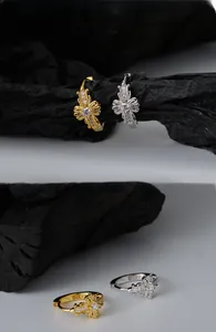 Macro shot of S925 sterling silver bow-knot earrings with zircon in gold and silver
