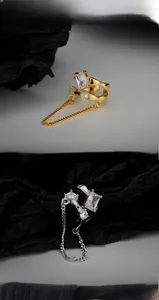 Detail of S925 silver ear cuffs with cubic zirconia inlay and elegant long chain tassels