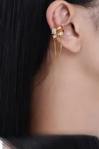 Macro view of gold-plated hollow double-layer geometric ear cuff with zircon tassels