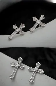 Detailed view of S925 sterling silver cross earrings with sparkling cubic zirconia stones