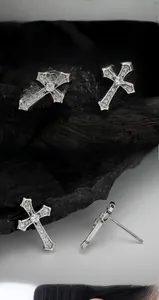 Macro detail of S925 sterling silver cross stud earrings with sparkling cubic zirconia