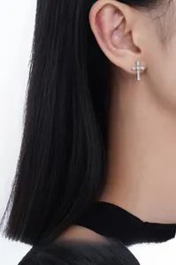 Macro view of sterling silver cross stud earring with micro-paved sparkling cubic zirconia