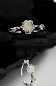 Macro detail of S925 silver opal ring showing irregular lava texture on dark stone background