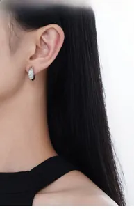 On-ear view of S925 sterling silver geometric hoop earrings with pavé set zirconia