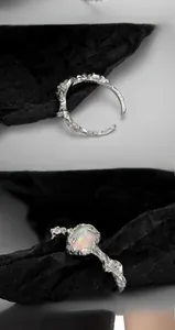 Macro detail of S925 sterling silver ring showing irregular lava texture and opal stone