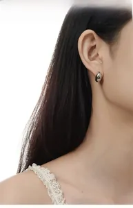 Polished S925 sterling silver waterdrop earrings shown on model for size and fit