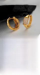 Close-up of gold and silver S925 sterling silver hoop earrings with pavé-set zircons