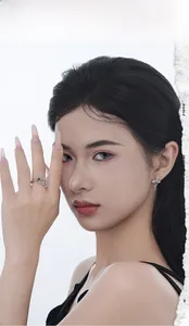 Close-up of S925 silver cross ring and earrings set with purple stones on a female model