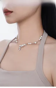 Dettaglio del pendente a stella in argento S925 e perle bianche su una collana corta