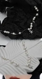 Dettaglio macro della collana a stella in argento S925 con perle bianche e pendente
