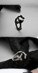 Macro shot of S925 sterling silver stamp on vintage cross and rose ring with red stone