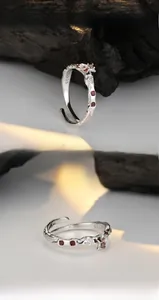 Macro detail of S925 sterling silver stamp and irregular lava texture on silver ring