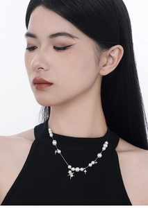 Dettaglio della collana di perle in argento S925 con pendenti a stella su modella